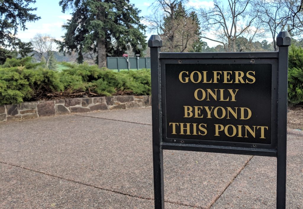 Photo of a sign that reads "Golfers only beyond this point"