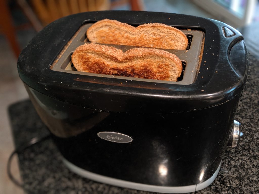 Image of toast popping in a toaster.